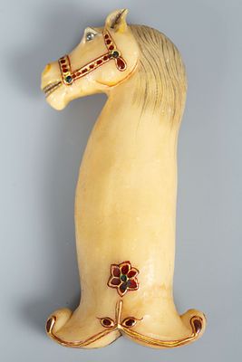 A Mughal Style Carved Hardstone/Jade Hilt. Carved as a horse head and decorated with polychrome 