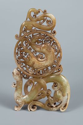 A Carved Russet Jade Ornament, China. Carved russet jade ornament with openwork decoration of 