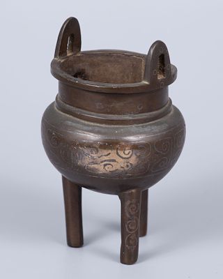 A Bronze and Silver Inlay Censer, China, Qing Dynasty (1644–1912). In tripod form, inlaid with 