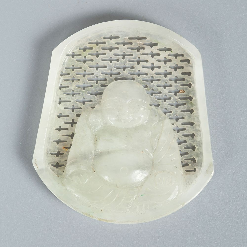 A Carved White Jade Buddha Plaque. The background features an openwork lattice pattern. The 