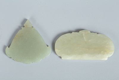 A Pair of Mughal Style Celadon Jade Plaques. The pieces are shaped in decorative forms with 