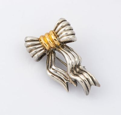 A Tiffany Sterling Silver and 18K Yellow Gold Bow Brooch. Marked and acid tested. 
Total weight: 