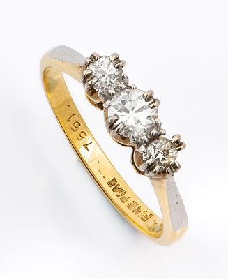 An 18K Yellow Gold Platinum and Diamond Ring. The top set with three diamonds (approx. 0.1 Ct in 