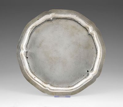A Silver Tray, Germany, Late 19th Century. Circular form with a scalloped floral rim, the 