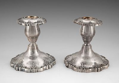 A Pair of Sterling Silver Candlesticks, Early 20th Century. Decorated with a floral pattern and 