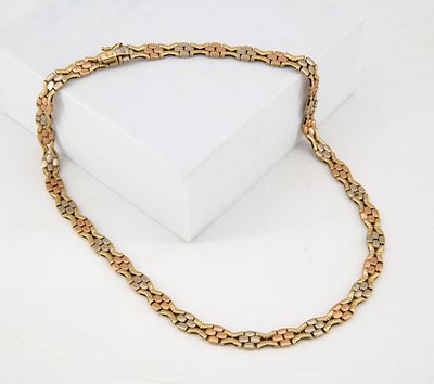A Fine 14K Three Tone Gold Necklace. Composed of a cluster of alternating rounded elements in 