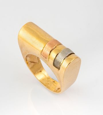 A 14K Three Tone Gold Designer Ring. A cylindrical upper section in yellow gold, decorated with 