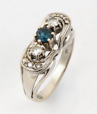 A 14k Gold Diamond and Sapphire Ring. Set with a natural blue sapphire and 0.10 ct diamonds on 