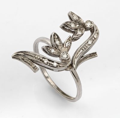 A 14K and 18K White Gold and Diamond Ring. With a 14K white gold band and an 18K white gold top 