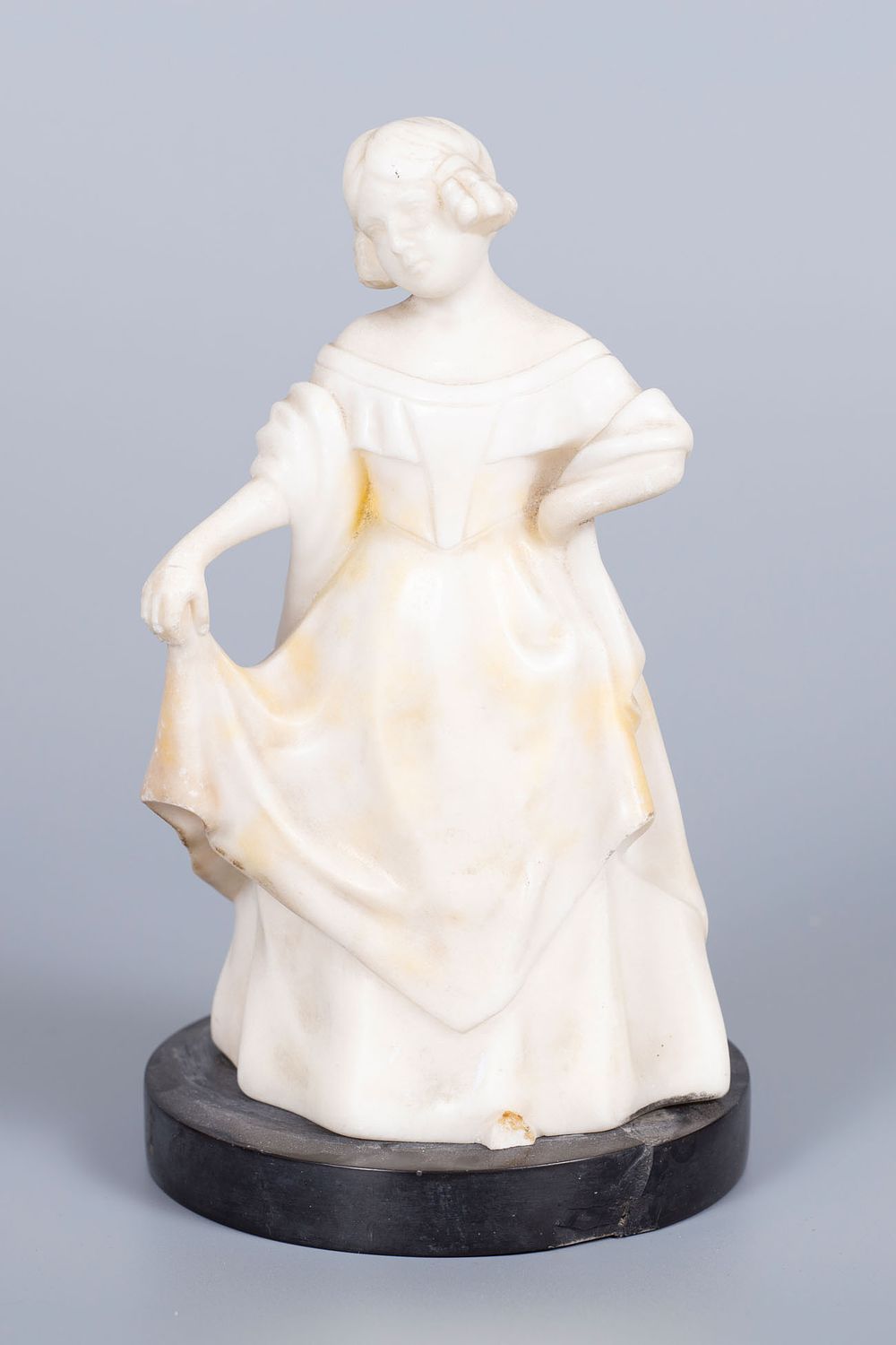 A Goldscheider White Marble Figurine, Vienna, Early 20th Century. Set on a black marble base. 