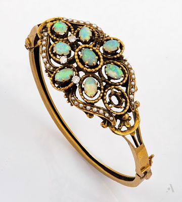 A Vintage 14K Yellow Gold Opal Pearl and Diamond Bangle Bracelet. Centered with an open work 