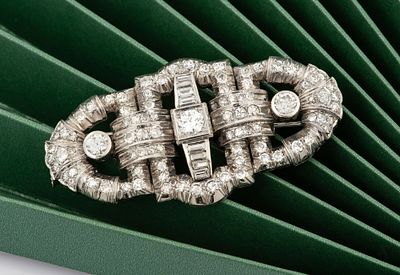 An Art Deco 14K White Gold and 3 Ct. Diamond Brooch. Designed as a buckle and centered by three 