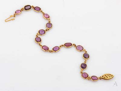A 14K Yellow Gold and 12 ct unheated Ruby Tennis Bracelet. Designed as a row 16 oval cut rubies 