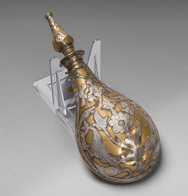 A Brass and Silver Inlay Powder Flask, Persia, 18th Century. Pear shaped flask decorated with 