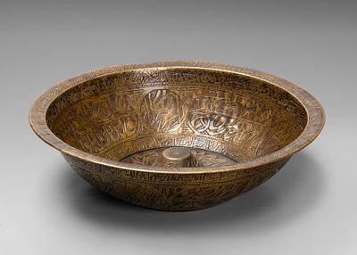 A Islamic Brass Divination Bowl, 18th-19th Century. With a broad rim, densely engraved with 