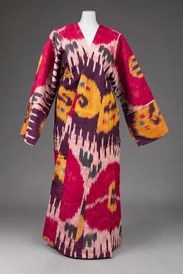 An Ikat Silk Coat, Bukhara, Early 20th Century. The fabric in in shades of purple and yellow. 