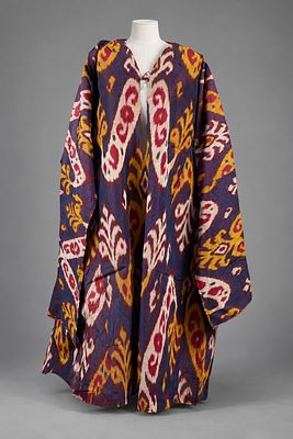 An Ikat Silk Tunic, Bukhara, Early 20th Century. The fabric in shades purple and yellow. Wear 