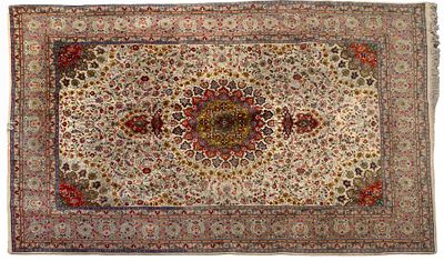 A Tabriz Rug, 20th Century. Decorated with a floral pattern on a green ground. Wear consistent 