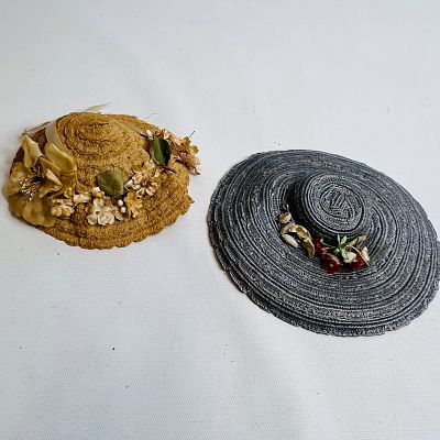 Two Antique Doll Hats, the tan one is ruffled woven straw hat, with millinery flowers, likely 