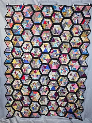 Vintage c1940 String Pieced Hexagon Quilt measuring 62 by 82 inches. It is comprised of 66 