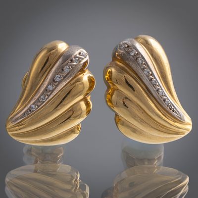 Pareja de pendientes en forma de venera en oro amarillo y oro blanco de 18kt con orla de brillantes.