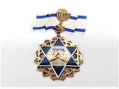 סיכת דש ברכת כוהנים עם סמל המדיה ודגל המדינה. סיכה זו נרכשה במכירה פומבית של מתנות לבכירים לפני 