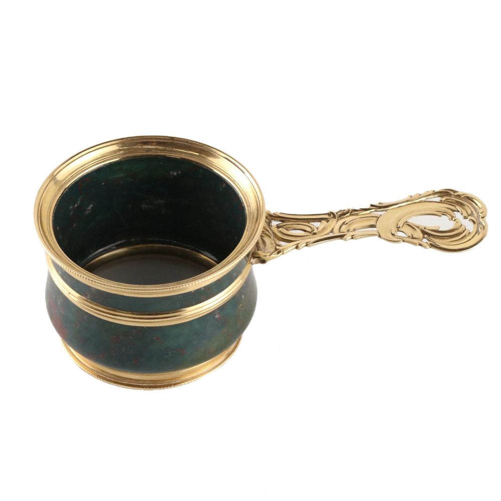 Magnifier in gold frame. Elegant magnifier in a gold frame with a pen in the form of a curl and 