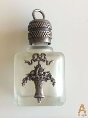 Perfume bottle. Perfume bottle, made of frosted glass, decorated with a silver finish 
