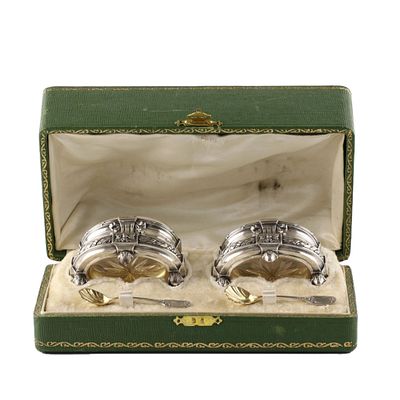 A pair of salt cellars in a gift case. A pair of French, silver salt cellars with spoons and 