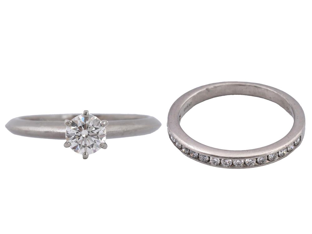 LOT OF TWO TIFFANY AND CO PLATINUM RINGS WITH DIAMONDS. A lot of two Tiffany and Co platinum 