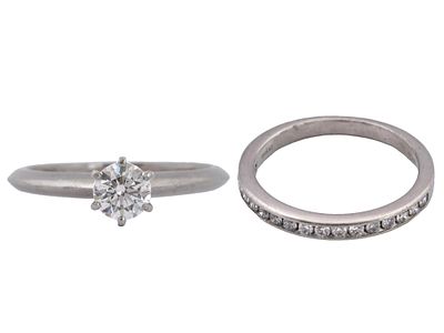 LOT OF TWO TIFFANY AND CO PLATINUM RINGS WITH DIAMONDS. A lot of two Tiffany and Co platinum