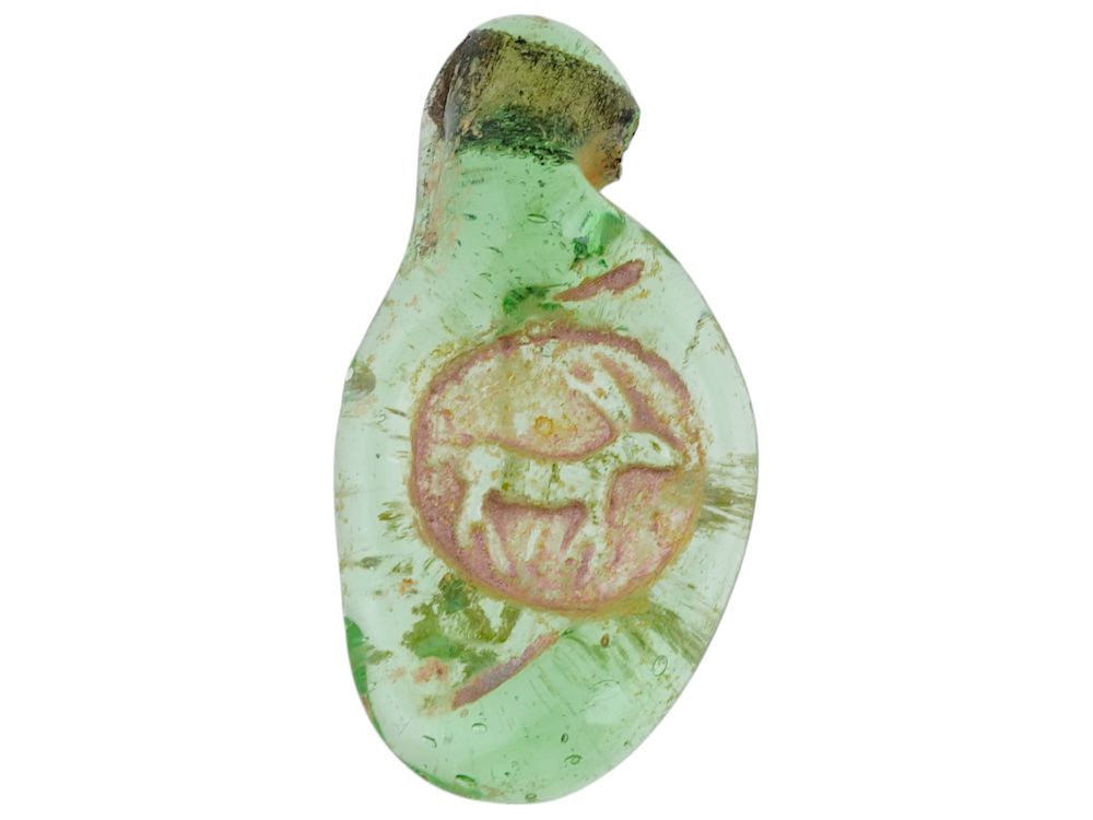 300 AD ROMAN ANIMAL GREEN GLASS MEDALLION PENDANT. An ancient Roman gree glass amulet pendant. 