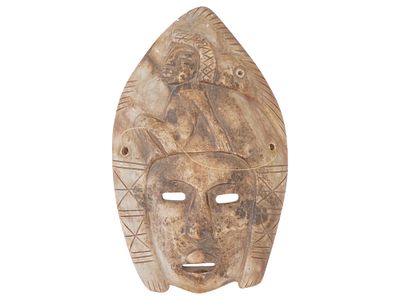 VINTAGE CARVED SOAPSTONE MASK WITH PIERCED EYES MOUTH. A vintage carved soapstone mask featuring 