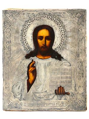 ANTIQUE RUSSIAN ORTHODOX JESUS ICON IN SILVER RIZA. An antique Russian Orthodox icon of Christ 