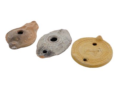ANCIENT ROMAN EMPIRE UNGLAZED TERRACOTTA OIL LAMPS. A group of 3 Ancient Roman terracotta oil 