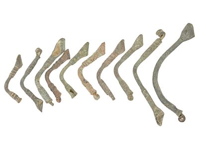 GROUP OF ANCIENT MEDITERRANEAN BRONZE FIBULAS. A lot of Ancient Mediterranean bronze fibulas. 