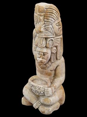 CARVED STONE SCULPTURE OF A MESOAMERICAN IDOL. A carved stone sculpture of a Mesoamerican idol. 