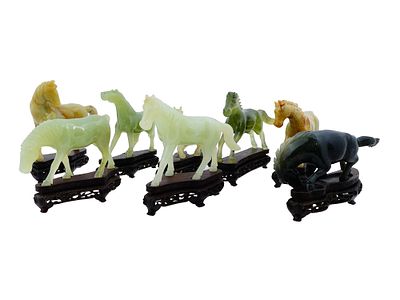 LOT OF CHINESE CARVED JADE HORSES FIGURES IN BOX. A collection of eight Chinese hand carved 