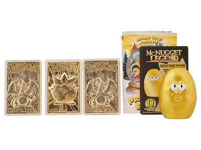 GOLD PLATED POKEMON TRADING CARDS AND MCNUGGET FIGURE. A group of promotional collectibles 