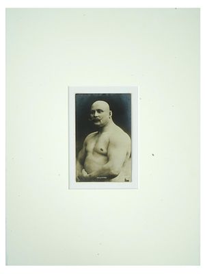 ANTIQUE RUSSIAN PORTRAIT PHOTO OF FAMOUS WRESTLER. An antique Russian post card with a black and 