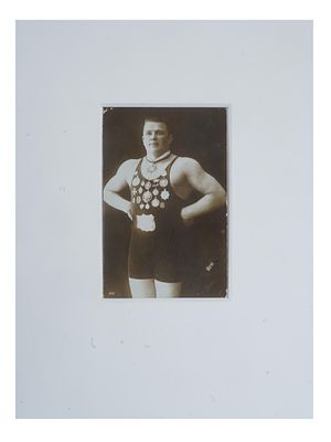 ANTIQUE RUSSIAN PORTRAIT PHOTO OF ESTONIAN WRESTLER. An antique Russian post card with a black 