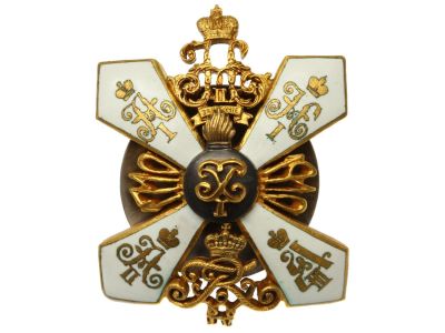 A RUSSIAN BADGE OF THE 3RD PERNOV GRENADIER REG. A stylized gold cross with white enamel 