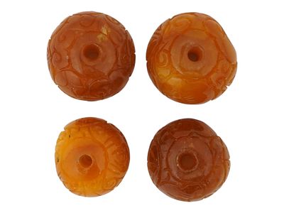 COLLECTION OF FOUR CHINESE HAND CARVED JADE BEADS. A collection of four hand carved jade beads 