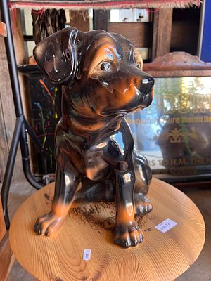 A mid-century ceramic figure of a life size Rottweiler puppy.