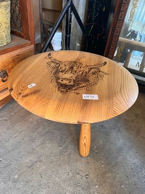 A contemporary hand made pine coffee table with highland cattle decoration.