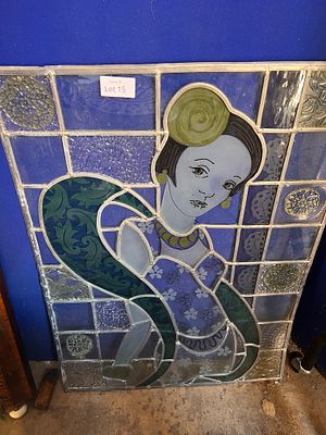 A leaded light and stained glass panel of an Art Deco lady. 71cm tall 54cm wide.