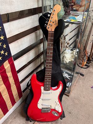 A Fender Squire Bullet Strat electric guitar with case.