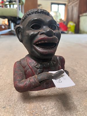 A genuine early 20th-century cast mechanical and painted money bank.