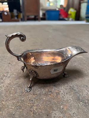 An HM silver three-footed gravy boat of plain form. 149g.