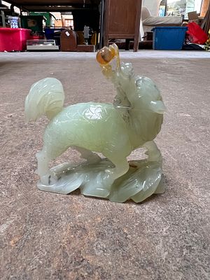 A Chinese export carved jade figure of a Fu Dog.